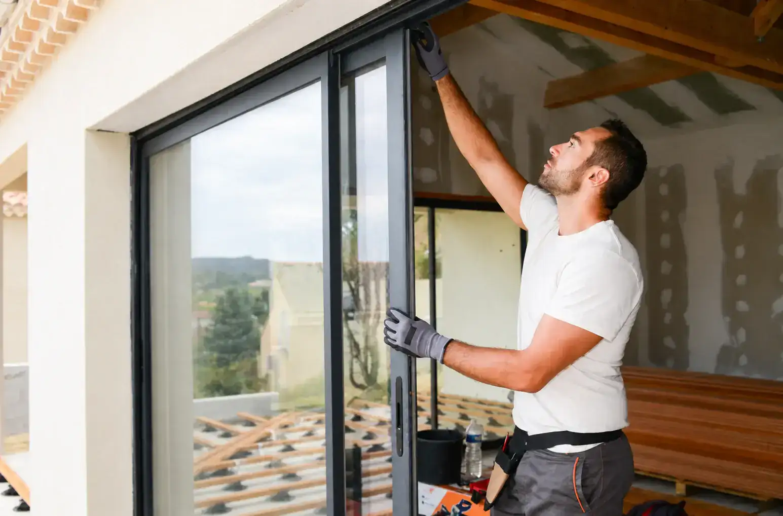 Window installer fitting a glass door for a local customer