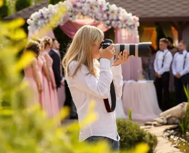 Photographer capturing an outdoor wedding celebration