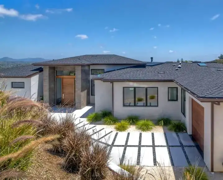 Modern hillside home exterior with landscaped entry
