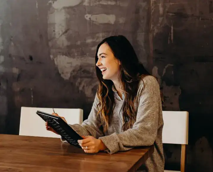 Professional smiling while working on a tablet